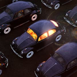 A bunch of vintage automobiles in a dark setting.